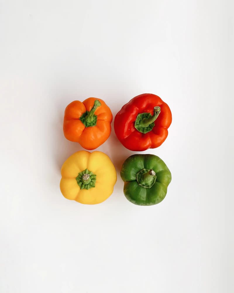 Colorful red, green, and yellow sweet bell peppers graded for export