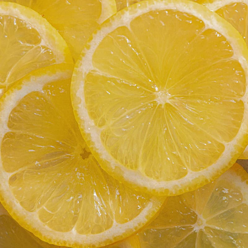 Fresh whole and halved yellow lemons with juicy citrus pulp